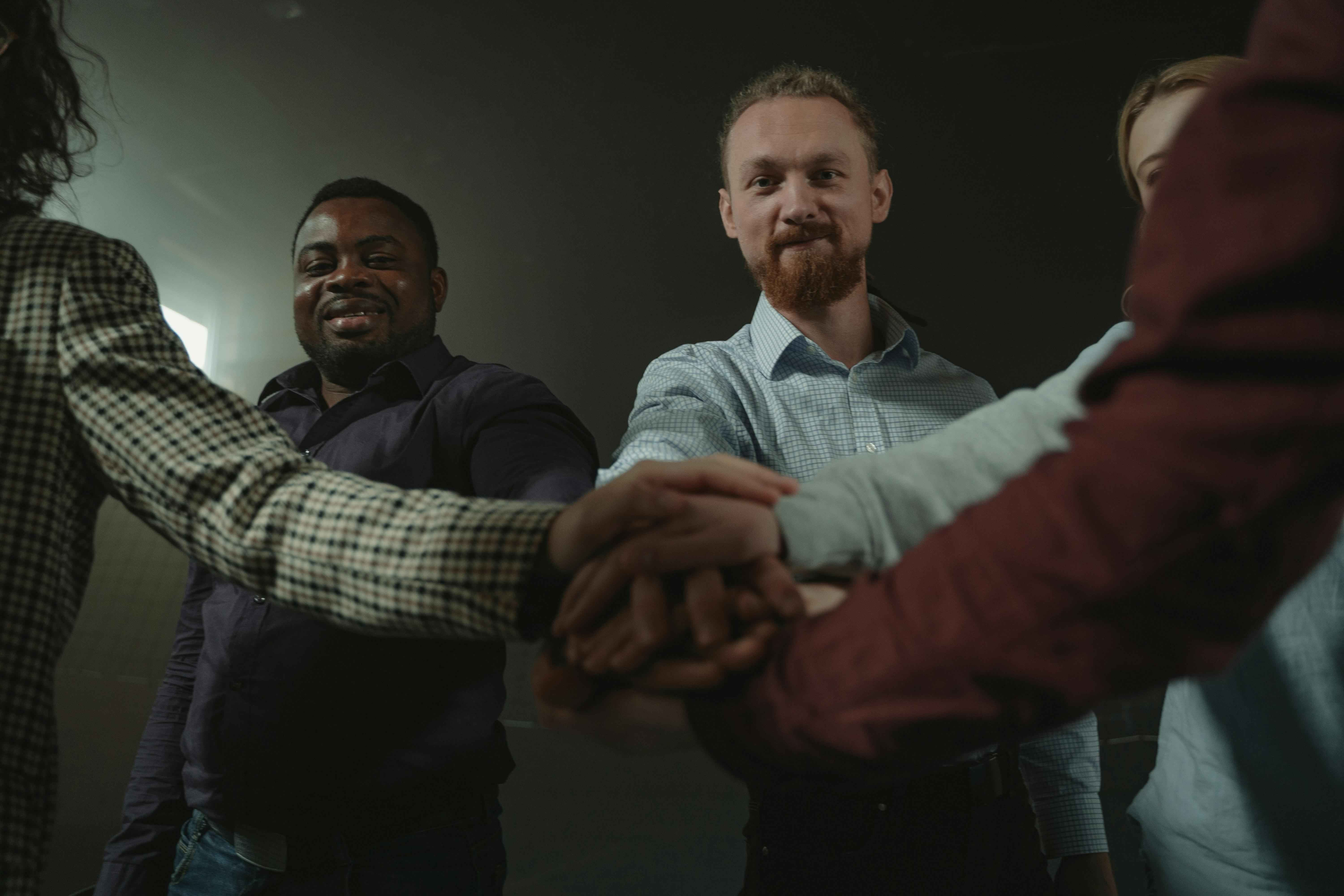 Men joining hands in support
